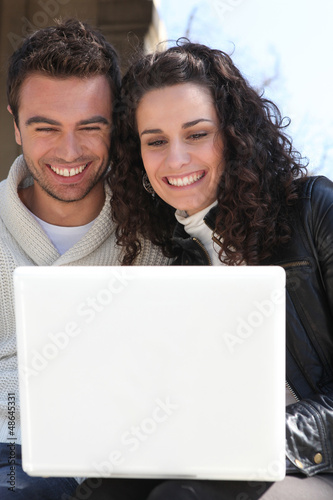 Photo: Couple outdoors with laptop Couple outdoors with laptop