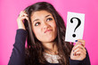 Photo: Doubtful Woman holding Question Mark Doubtful Woman holding Question Mark