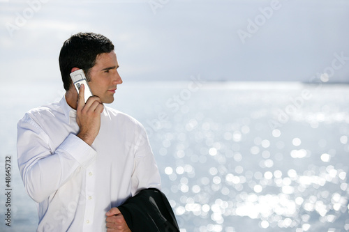 Photo: Businessman stood by the sea Businessman stood by the sea