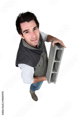 Photo: Bricklayer with a block Bricklayer with a block