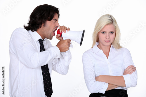 Photo: Man shouting into a woman's ear Man shouting into a woman's ear