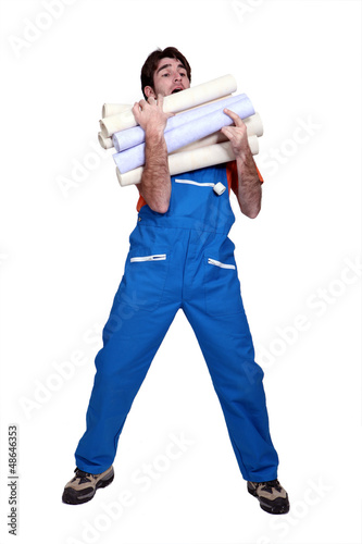 Photo: Man laden with rolls of wallpaper Man laden with rolls of wallpaper