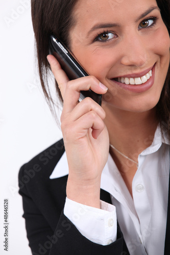 Photo: Young businesswoman holding mobile telephone Young businesswoman holding mobile telephone