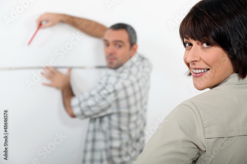 Photo: couple planning improvements in their apartment couple planning improvements in their apartment