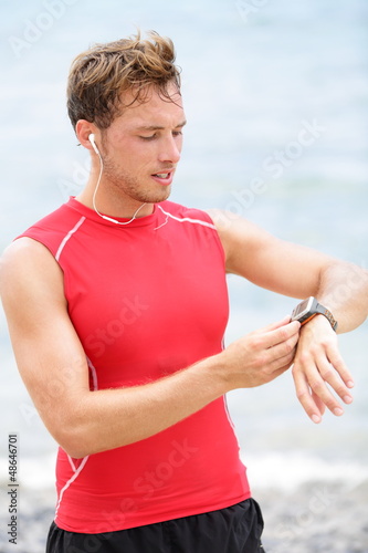 Photo: Running man looking at heart rate monitor Running man looking at heart rate monitor