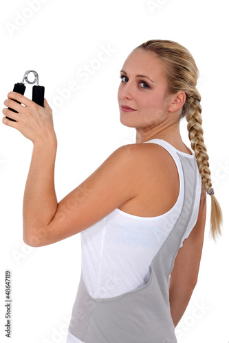 Photo: Woman holding grippers Woman holding grippers