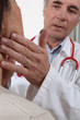 Doctor examining his patient's glands
