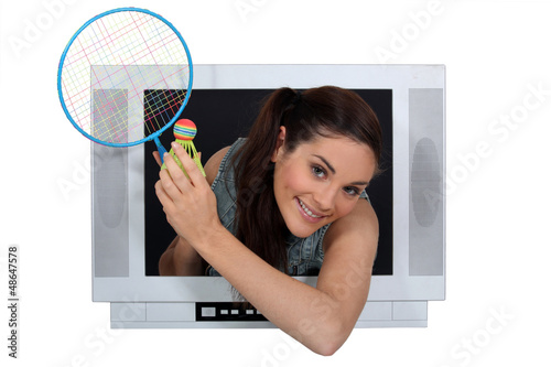 Photo: girl in TV screen with badminton racket girl in TV screen with badminton racket