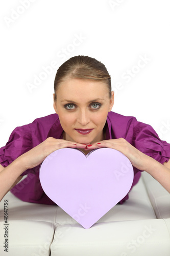 Photo: Young woman with a heart-shaped box Young woman with a heart-shaped box