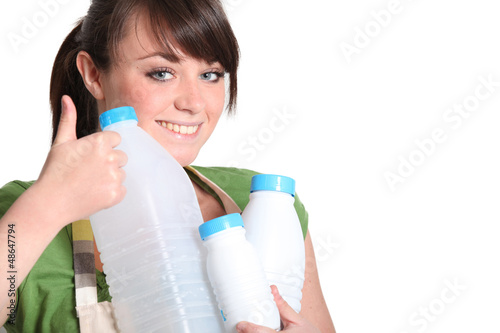 Photo: Young woman recycling plastic bottles Young woman recycling plastic bottles