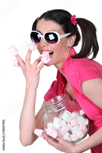 Photo: Candy-sweet woman with a jar a marshmallows Candy-sweet woman with a jar a marshmallows