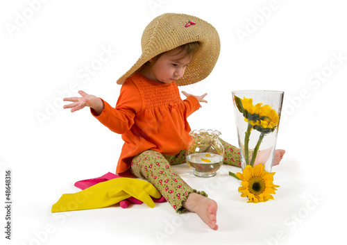 Photo: One little girl arranging flowers sitting One little girl arranging flowers sitting
