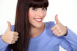 Attractive woman giving two thumbs up