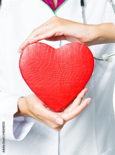 Photo: medical doctor holding red heart medical doctor holding red heart