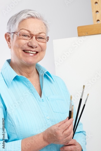 Photo: Active pensioner with paintbrush and canvas Active pensioner with paintbrush and canvas