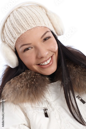 Photo: Closeup portrait of smiling winter girl Closeup portrait of smiling winter girl