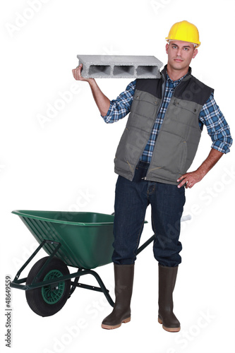 Photo: craftsman holding a stone block craftsman holding a stone block