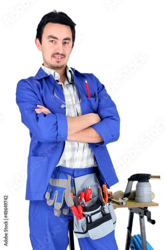 Photo: Full length studio shot of a plumber and his tools Full length studio shot of a plumber and his tools