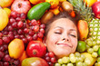 Photo: Happy girl in group of fruit. Happy girl in group of fruit.