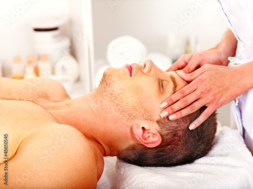 Photo: Man getting facial massage . Man getting facial massage .