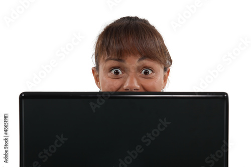 Photo: Terrified woman with a laptop Terrified woman with a laptop