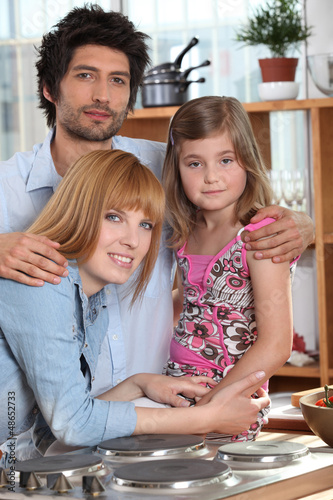 Photo: Parents and their daughter in the kitchen Parents and their daughter in the kitchen