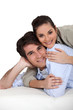 Woman lying on top of boyfriend