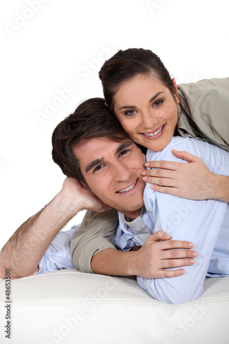 Photo: Woman lying on top of boyfriend Woman lying on top of boyfriend