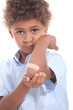 Photo: Little boy with a plaster on his arm Little boy with a plaster on his arm
