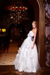 sexy blond bride in white wedding dress in interior