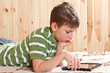 teenager boy lying on the bed with a Tablet PC