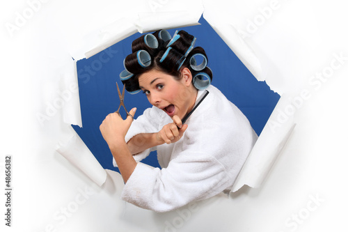 Photo: Woman in rollers with hairdressing scissors Woman in rollers with hairdressing scissors