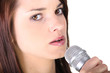 Woman singing into a microphone