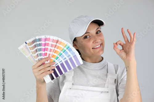 Photo: Decorator with a colour chart Decorator with a colour chart