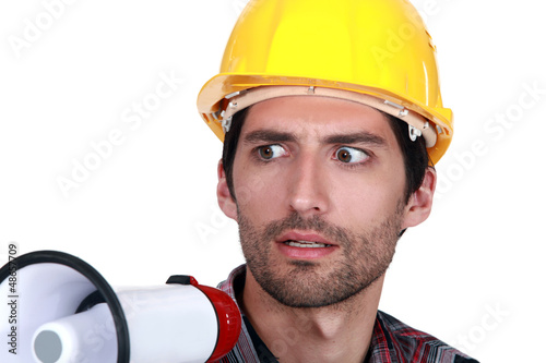 Photo: A disturbed tradesman holding a megaphone A disturbed tradesman holding a megaphone