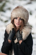 Photo: Sexy beautiful brunette girl in winter clothes in park Sexy beautiful brunette girl in winter clothes in park