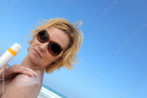 Photo: Woman applying sun cream Woman applying sun cream