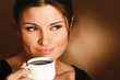 Woman with an aromatic coffee in hands