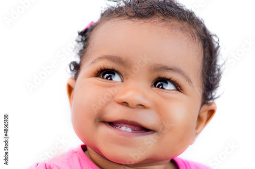Photo: Beautiful ethnic 9 month old baby looking up and smiling Beautiful ethnic 9 month old baby looking up and smiling
