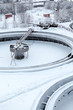 Photo: Snow-covered empty round settlers in sewerage treatment plant Snow-covered empty round settlers in sewerage treatment plant
