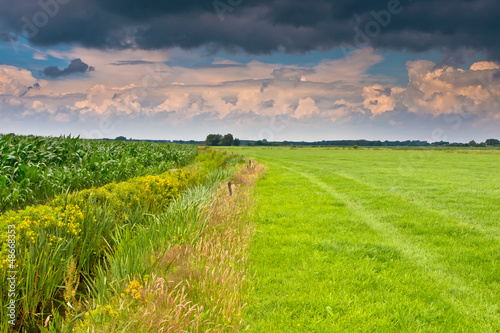 Photo: dramatic sky above dutch agricultural landscape dramatic sky above dutch agricultural landscape