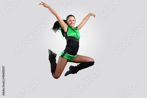 Photo: Young female dancer against white background Young female dancer against white background