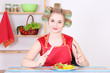 Photo: young housewife eating in the kitchen young housewife eating in the kitchen
