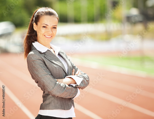 Photo: Business woman at athletic stadium Business woman at athletic stadium
