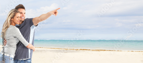 Photo: Happy couple on the beach. Happy couple on the beach.