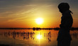 Young muslim woman praying at sunset