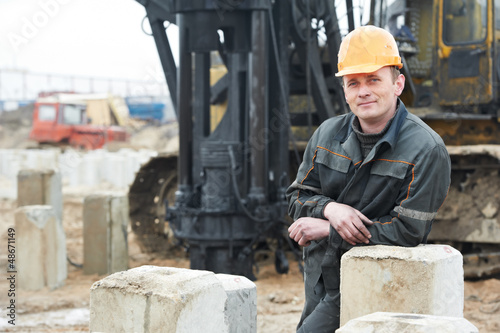 Photo: builder in dirty workwear at construction site builder in dirty workwear at construction site