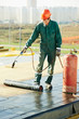 Flat roof covering repair works with roofing felt