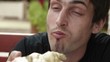 Man eating pizza in cafe