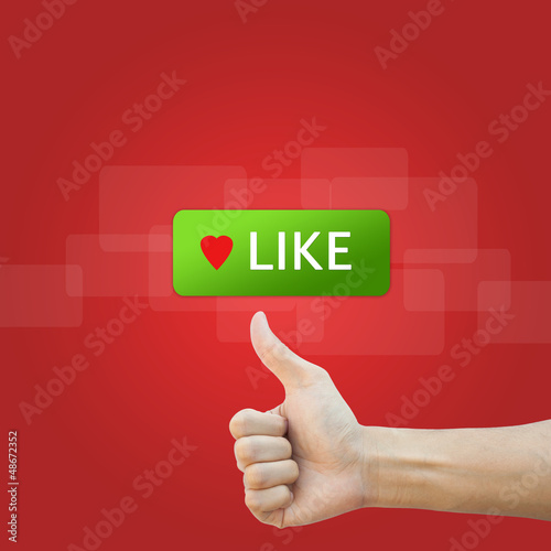 Photo: like button with real hand on red background like button with real hand on red background